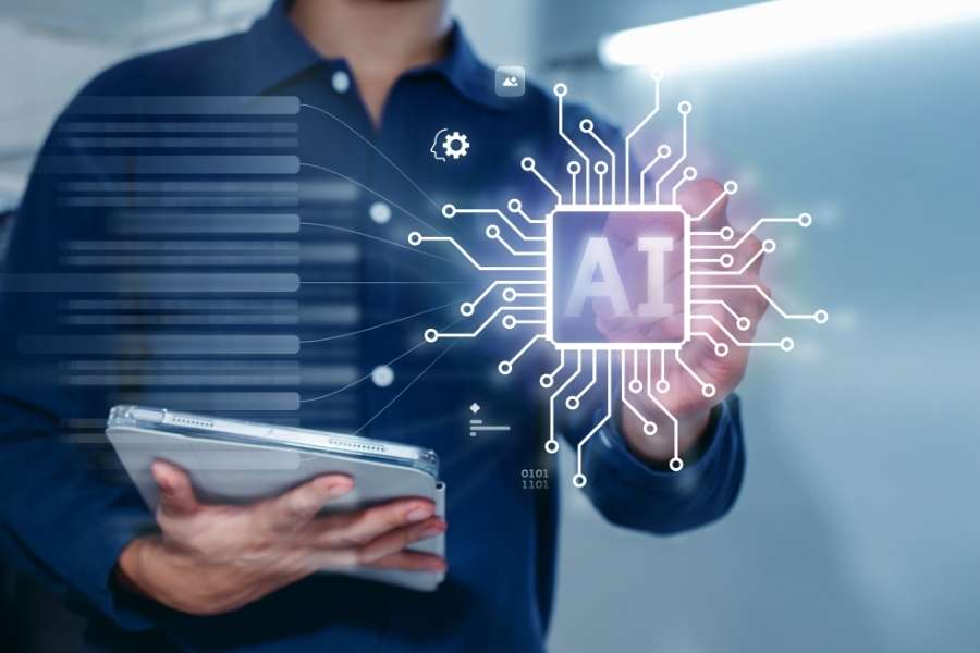 A professional holding a tablet while interacting with a glowing AI microchip interface representing latest AI technology trends.